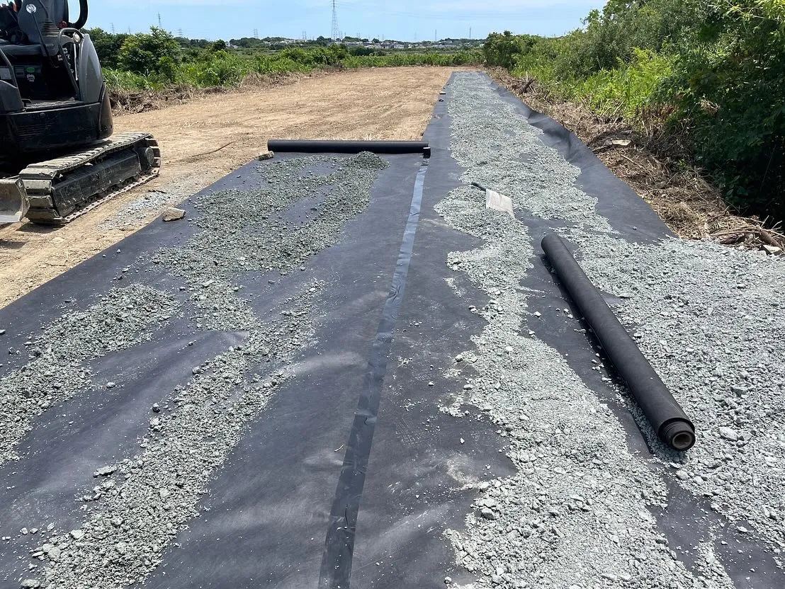 広範囲な整地で防草シートを敷いてから砕石敷き均し転圧作業